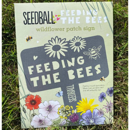 "Feeding the Bees" stainless steel sign by Seedball in cardboard packaging