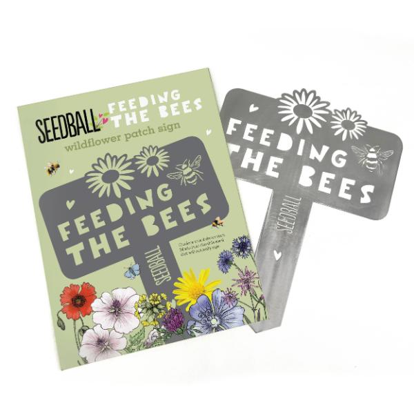 "Feeding the Bees" stainless steel sign by Seedball shown alongside cardboard packaging