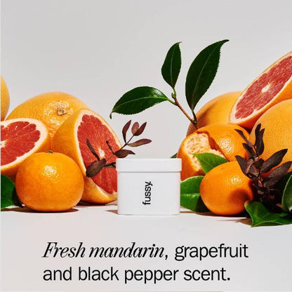 Fussy deodorant with mandarin, grapefruit, and black pepper text on a light grey background