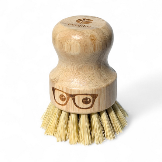 Wooden 'geeky' pot brush with a spectacled face design on a white background