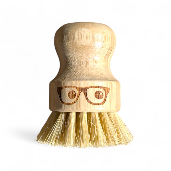 Wooden 'geeky' pot brush with a spectacled face design on a white background
