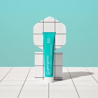 Georganics fluoride toothpaste with hydroxyapatite for fresh mint flavor, showing the toothpaste tube on a white background.