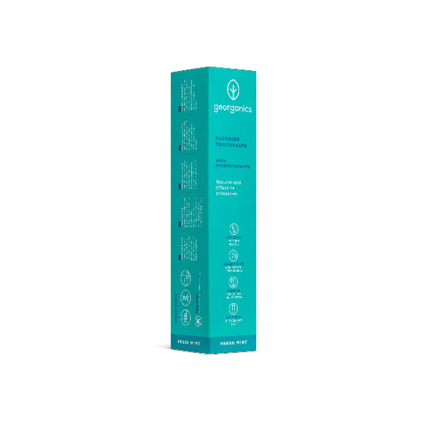 Georganics fluoride toothpaste with hydroxyapatite and fresh mint flavor in a white tube on a box, designed for oral care.