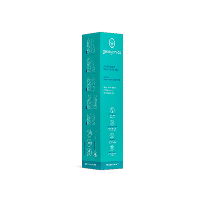 Georganics fluoride toothpaste with hydroxyapatite and fresh mint flavor in a white tube on a box, designed for oral care.
