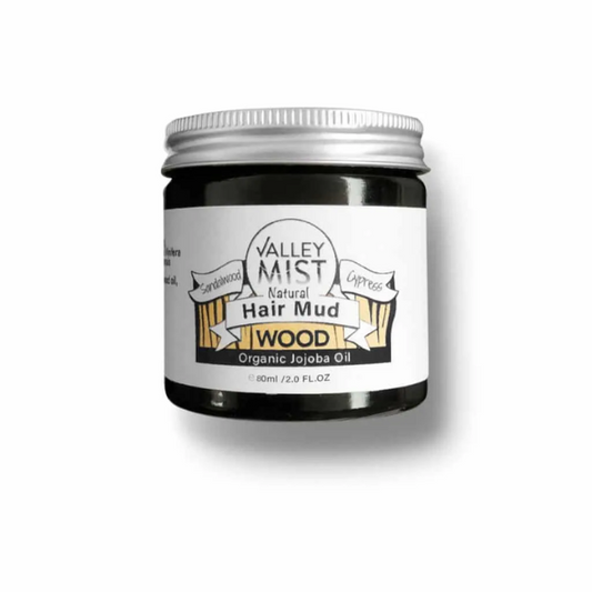 Valley Mist hair styling mud in glass jar with metal lid on white background