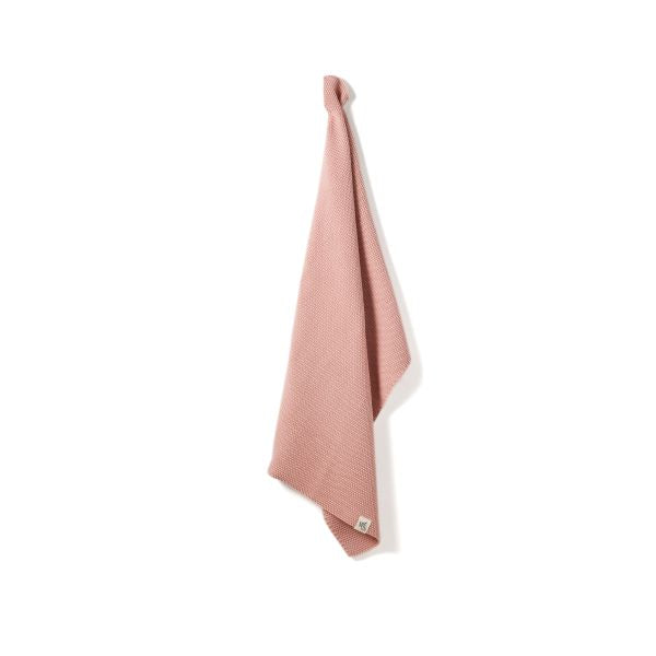 Knitted cotton hand towel in Rose pink shown hanging up