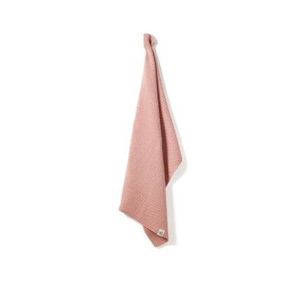 Knitted cotton hand towel in Rose pink shown hanging up