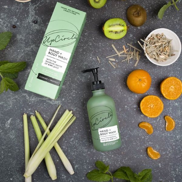 UpCircle hand and body wash shown alongside kiwis, lemongrass and satsumas