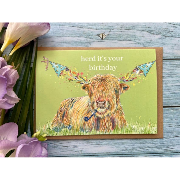 Eco birthday card, lime background with a highland cow wearing a party hat on each horn with the words "herd it's your birthday" 