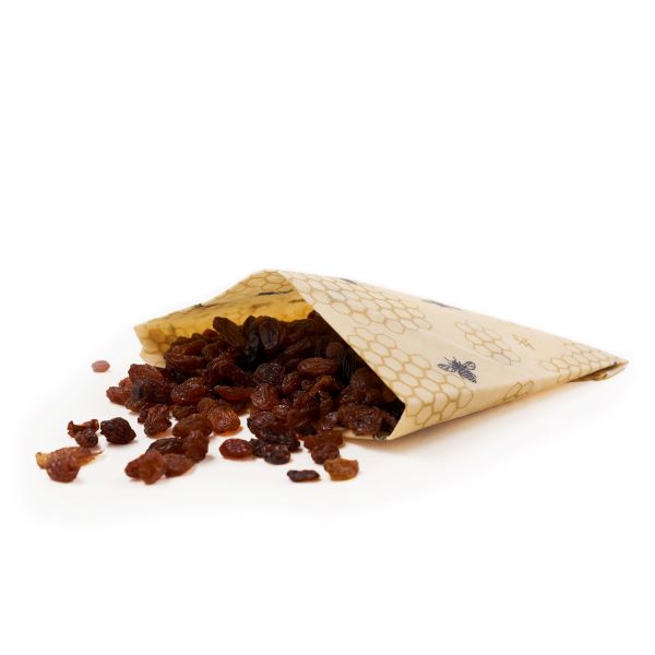 Beeswax wrap folded into a pouch containing raisins