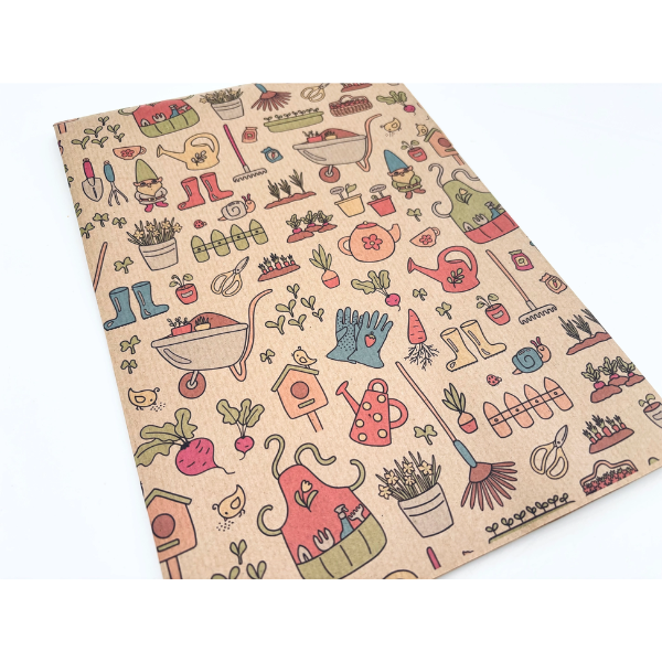 Planetwrapit eco-friendly wrapping paper folded, featuring a pattern of colourful gardening implements, plants, watering can etc on a brown kraft paper background.