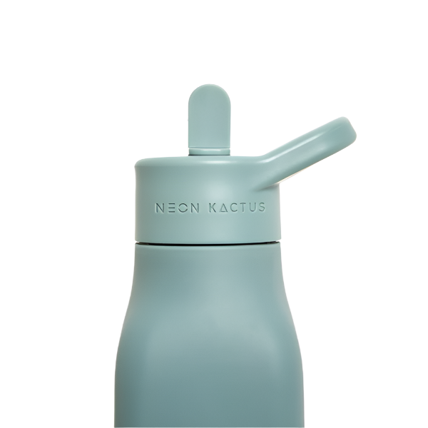 Kids reusable silicone bottle in Happy Camper colourway (an olive green) shown close up with straw lid on