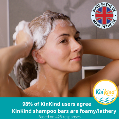 Woman washing her hair with KinKind shampoo bar, featuring the brand logo and text reading "98% of KinKind users agree KinKind shampoo bars are foamy/lathery based on 428 responses"