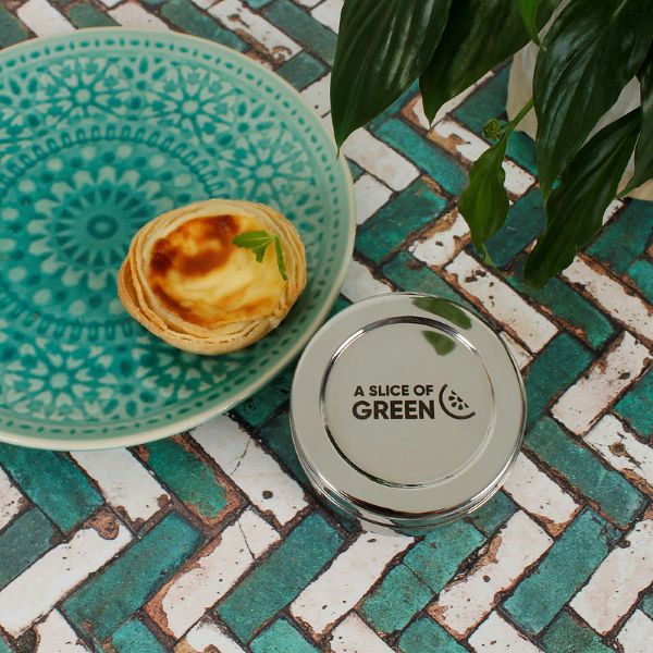 Stainless steel mini food container shown alongside a custard tart, which would fit inside perfectly