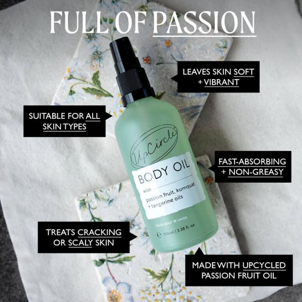 UpCircle body oil bottle on a floral background with text reading "Full of passion; Leaves skin soft and vibrant; suitable for all skin types; Fast-absorbing and non-greasy; Treats cracking or scaly skin; Made with upcycled passion fruit oil"