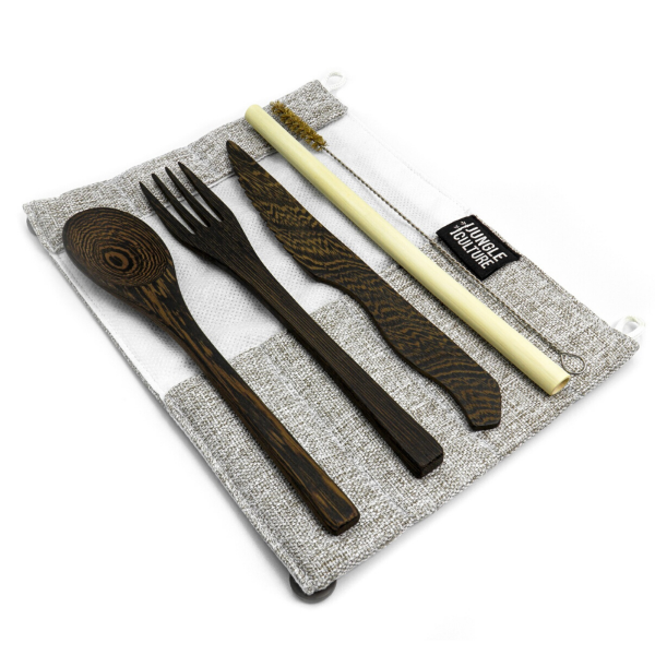 Set of wooden cutlery and bamboo straw on a light grey fabric pouch