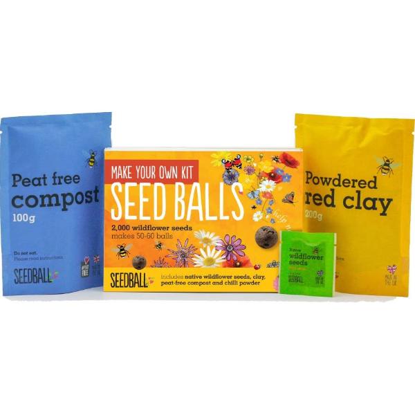 Make your own seedball set in cardboard box with peat-free compost, seed balls, and powdered red clay on a white background.