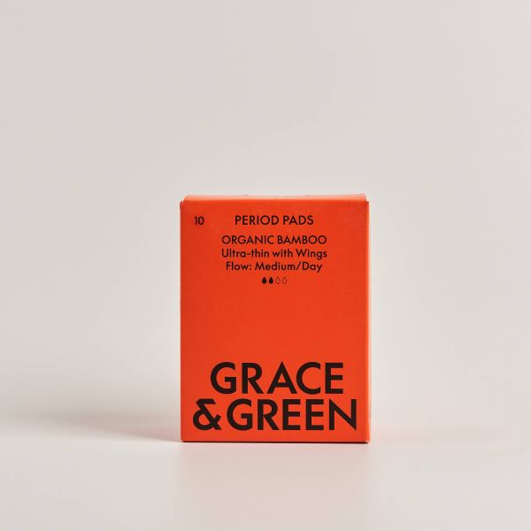Red box of Grace & Green organic bamboo period pads in medium on a light background