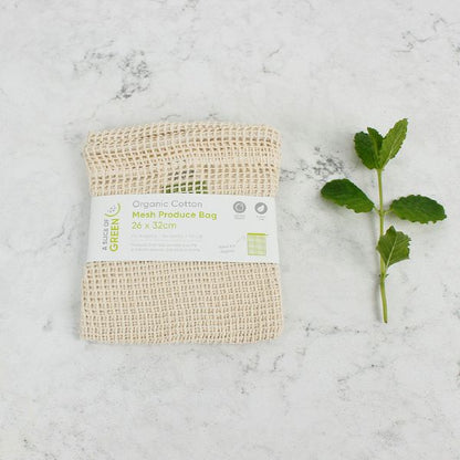 Mesh produce bag with paper label on a marble surface