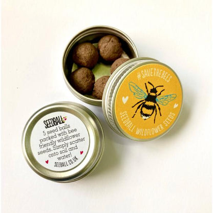 Mini seedball tin with a bee design on the lid, wildflower seedballs inside.