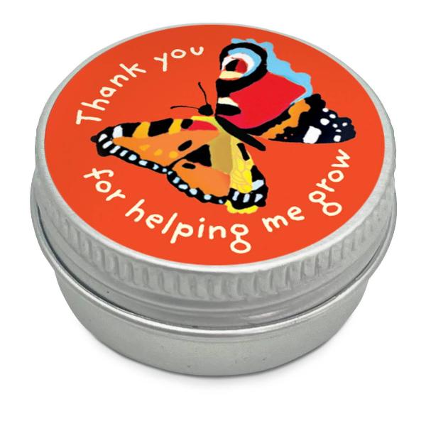 Mini seedball tin with a colourful red butterfly illustration and text reading "Thank you for helping me grow" on a  white background