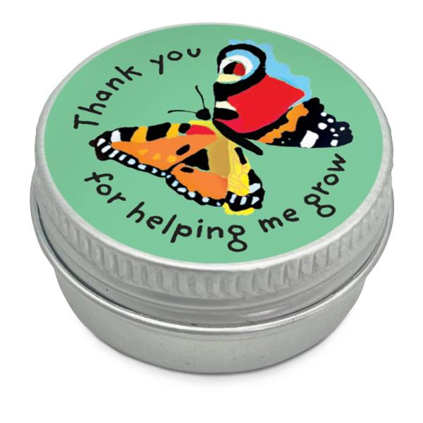 Mini seedball tin with a green colourful butterfly illustration and text reading "Thank you for helping me grow" on a white background