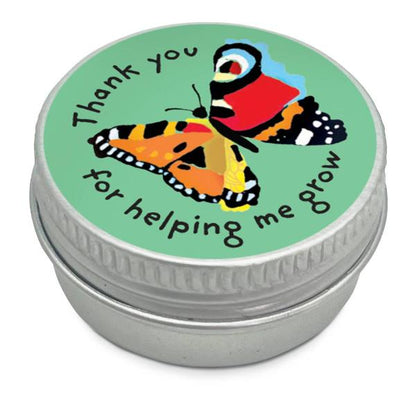Mini seedball tin with a green colourful butterfly illustration and text reading "Thank you for helping me grow" on a white background