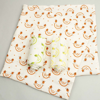 Organic cotton set of three muslin cloths, one shown opened out and the other two rolled up. All with cream background then colourful fruity images 