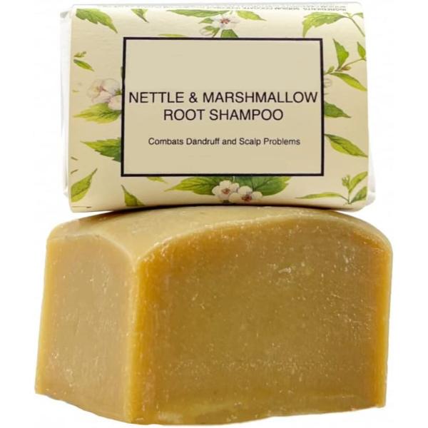 Shampoo bar shown wrapped and unwrapped with paper label reading 'Nettle & marshmallow root shampoo" and "combats dandruff and scalp problems"