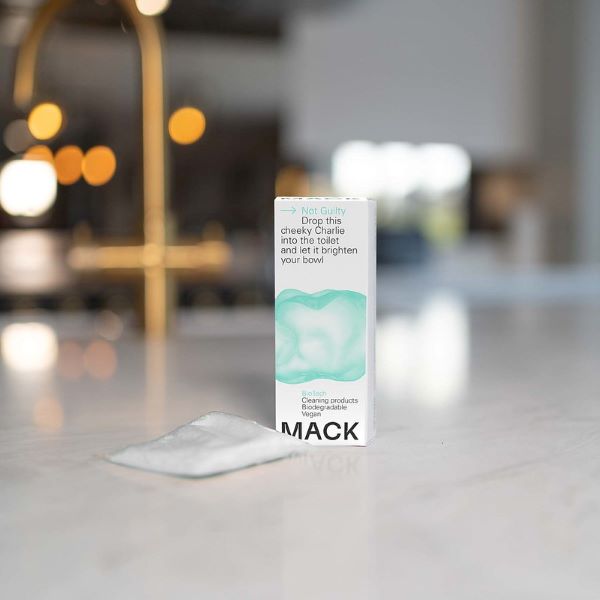 Mack toilet cleaning pod in cardboard box with text reading "Not guilty Drop this cheeky Charlie into the toilet and let it brighten your bowl" shown with pod alongside