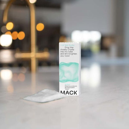 Mack toilet cleaning pod in cardboard box with text reading "Not guilty Drop this cheeky Charlie into the toilet and let it brighten your bowl" shown with pod alongside