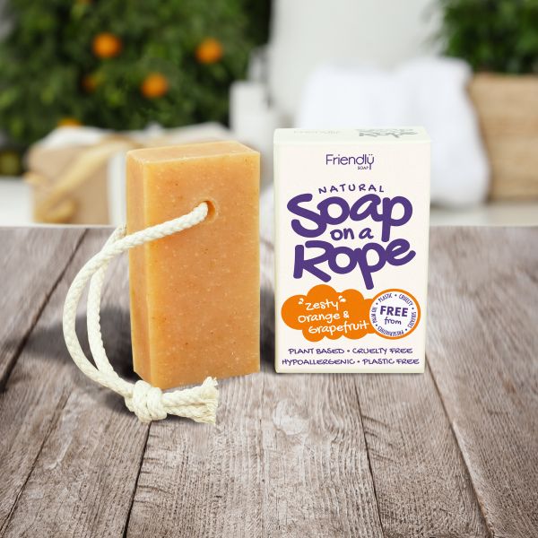 Friendly Soap soap on a rope in zesty orange and grapefruit shown alongside cardboard box