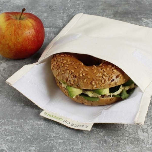 Organic cotton snack bag shown with bagel inside next to an apple