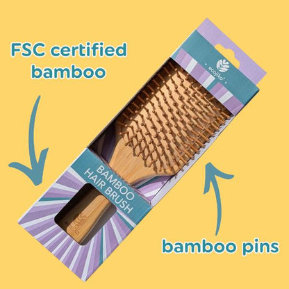 Bamboo hair brush in packaging with text reading "FSC certified bamboo" and "bamboo pins" on a yellow background