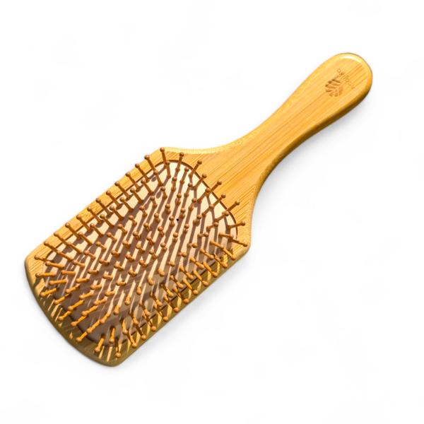 Wooden paddle hairbrush on a white background