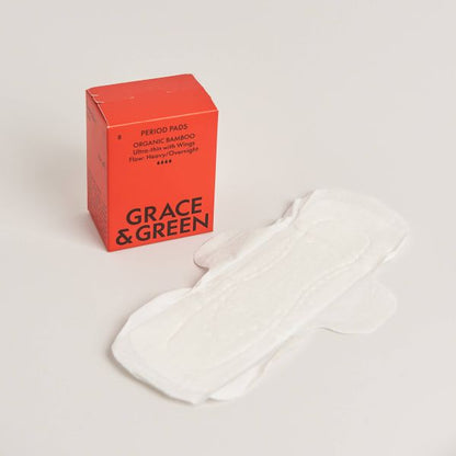 Red box of Grace & Green period pads on a light background