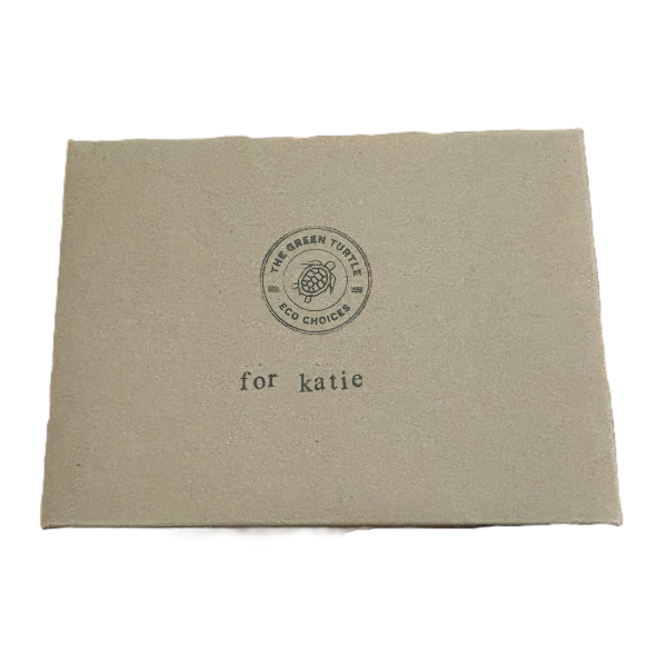Cardboard box lid with The Green Turtle logo and stamped text reading 'for katie'