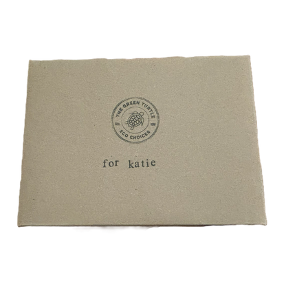Cardboard box lid with The Green Turtle logo and stamped text reading 'for katie'