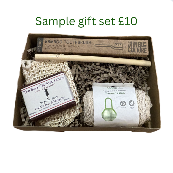 Sample personalised sustainable gift set worth £10 with bamboo toothbrush, bamboo straw, soap, sisal soap bag and string shopping bag in a cardboard box with shredded kraft paper.