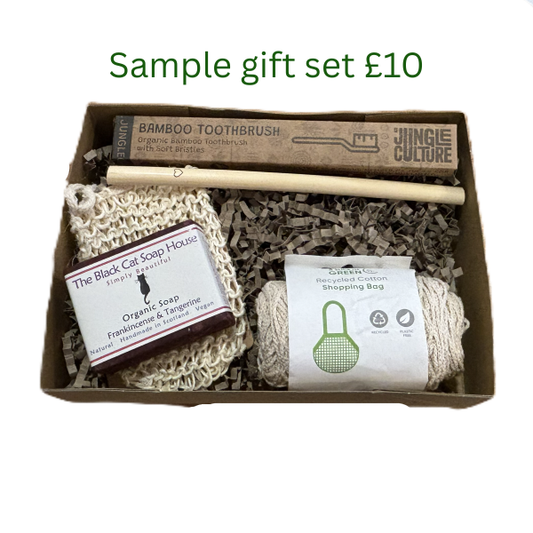 Sample personalised sustainable gift set worth £10 with bamboo toothbrush, bamboo straw, soap, sisal soap bag and string shopping bag in a cardboard box with shredded kraft paper.