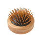 Wooden round pop-up travel hairbrush with bristles pushed outside