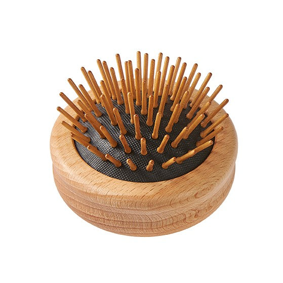 Wooden round pop-up travel hairbrush with bristles pushed outside