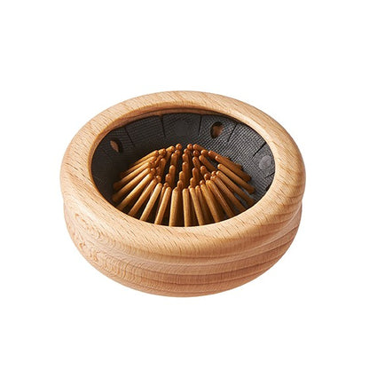 Wooden round pop-up travel hairbrush with bristles pushed inside