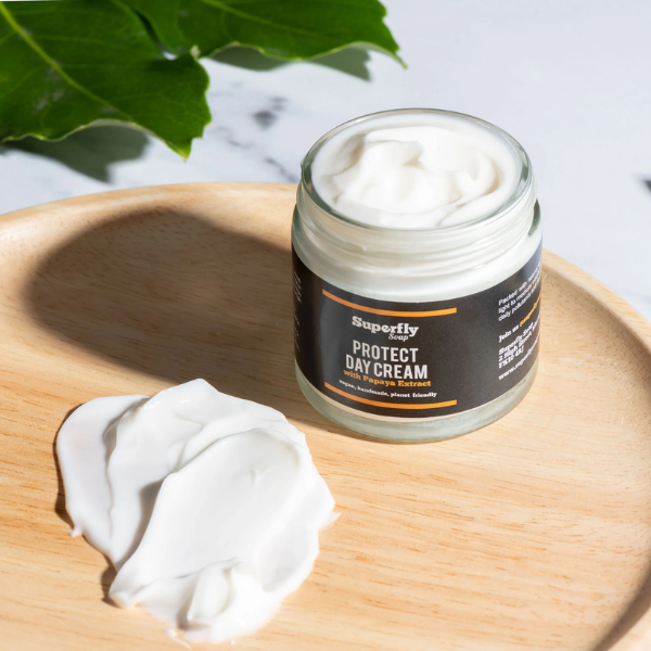 Protect Day cream in glass jar with lid off showing cream inside