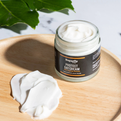 Protect Day cream in glass jar with lid off showing cream inside