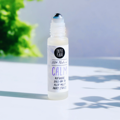 Natural pulse point roll with lid off, with text on label reading '100% natural Calm natural roll-on to help melt away stress'