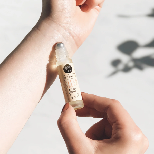 Natural pulse point roll shown being applied to wrist, with text on label reading '100% natural Sleep natural roll-on to help you drift off'