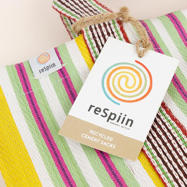 Recycled cement sack in 'Beach' colourway (yellow, white, pink, green stripes) with ReSpiin paper tag shown close up