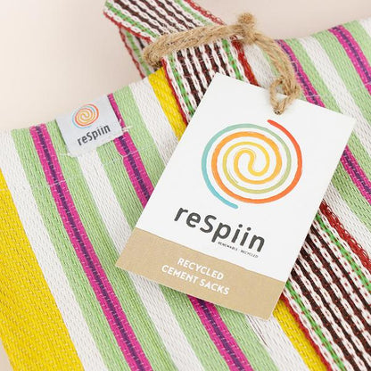 Recycled cement sack in 'Beach' colourway (yellow, white, pink, green stripes) with ReSpiin paper tag shown close up