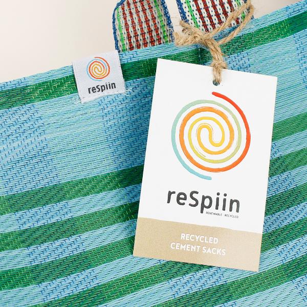 Recycled cement sack in 'Ocean' colourway (blue and green stripes) with ReSpiin paper tag shown close up 